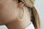 Large Gold Matt Hoop Earrings On Model 