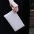 Ivory leather clutch bag modelled | Lily Gardner London