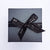 black  gift box with ribbon bow and silver logo Lily Gardner