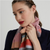 model wearing pink wallace sewell striped scarf at neck close up
